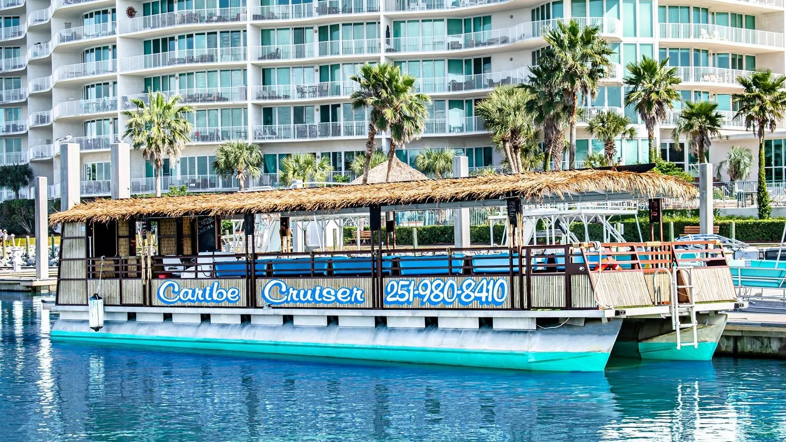 The Caribe Cruiser tiki boat moored at Caribe Marina
